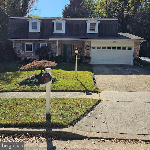 view of front of home with a garage and a front lawn