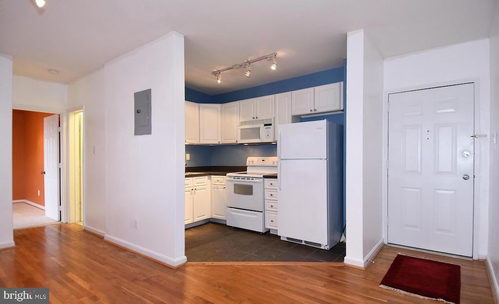 kitchen with white cabinetry, white appliances, and dark hardwood / wood-style floors