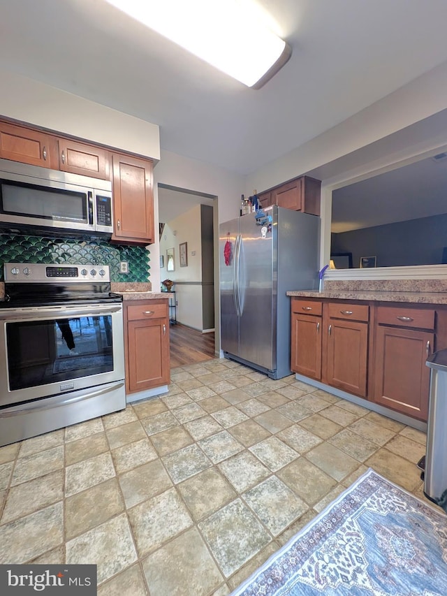 kitchen featuring decorative backsplash and appliances with stainless steel finishes