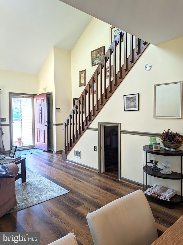 living room featuring dark hardwood / wood-style flooring and vaulted ceiling