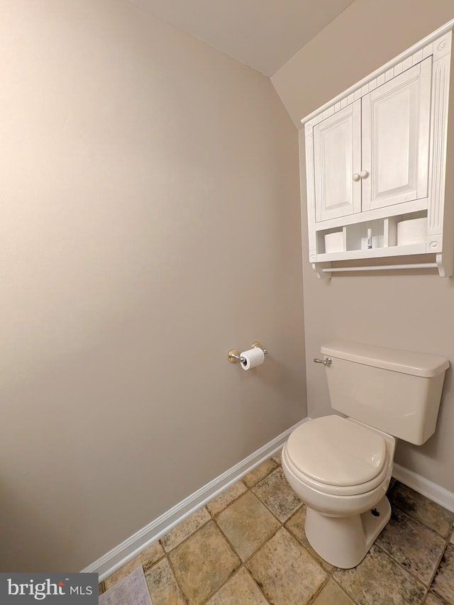 bathroom featuring toilet and lofted ceiling