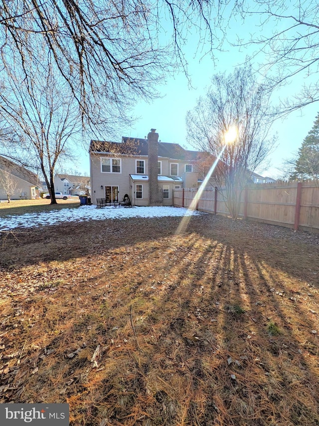 back of house featuring a yard