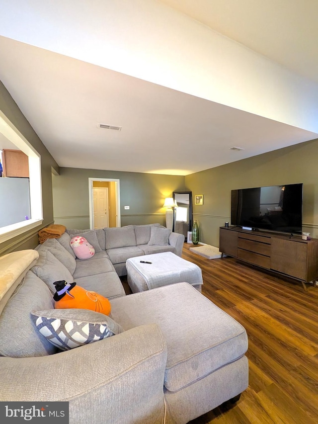 living room featuring dark wood-type flooring