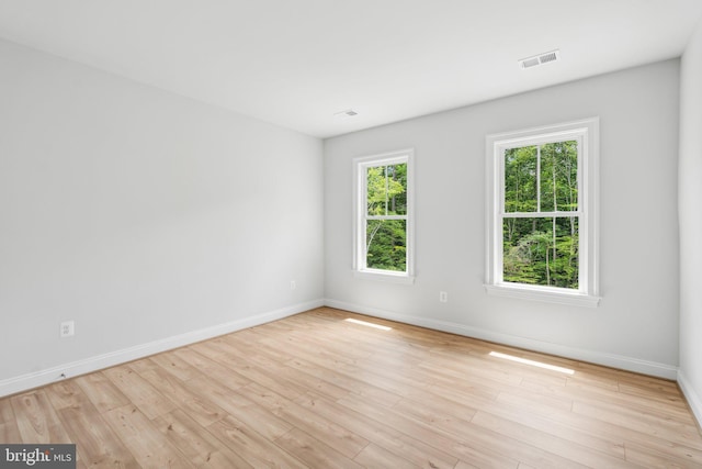 unfurnished room with light wood-type flooring