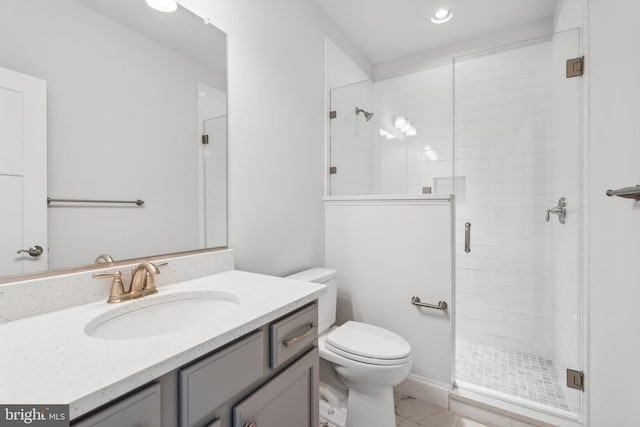 bathroom featuring a shower with shower door, toilet, and vanity