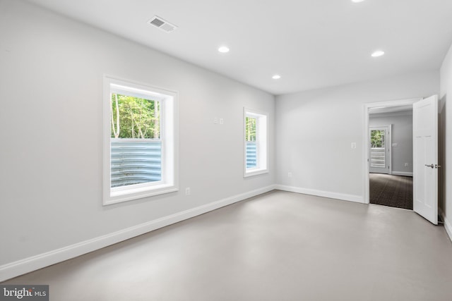 spare room featuring concrete flooring