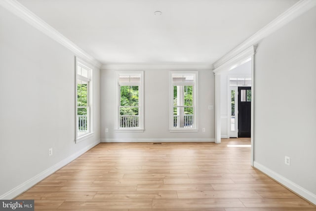 unfurnished room with light wood-type flooring and ornamental molding