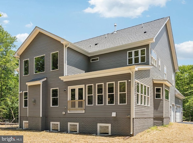 rear view of house with a garage