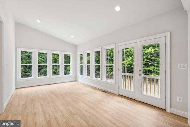 unfurnished sunroom featuring vaulted ceiling