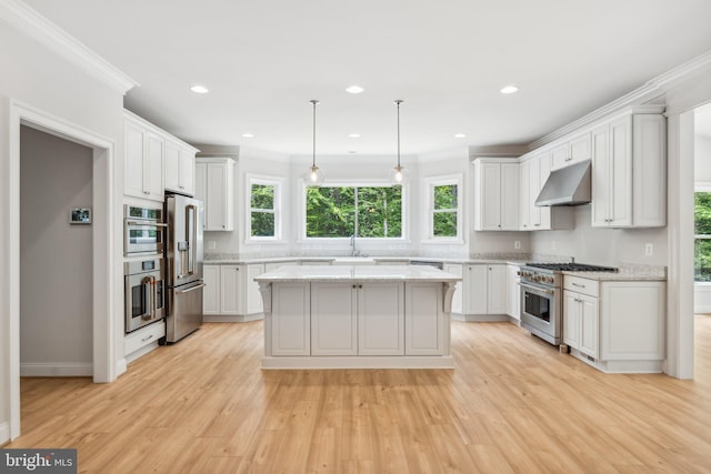 kitchen featuring a center island, high end appliances, white cabinets, and light hardwood / wood-style floors