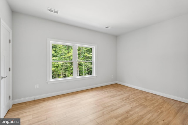 spare room featuring light hardwood / wood-style flooring