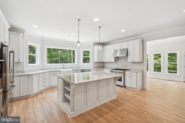 kitchen with stainless steel appliances, a kitchen island, white cabinetry, and hanging light fixtures