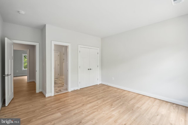 unfurnished bedroom with light wood-type flooring