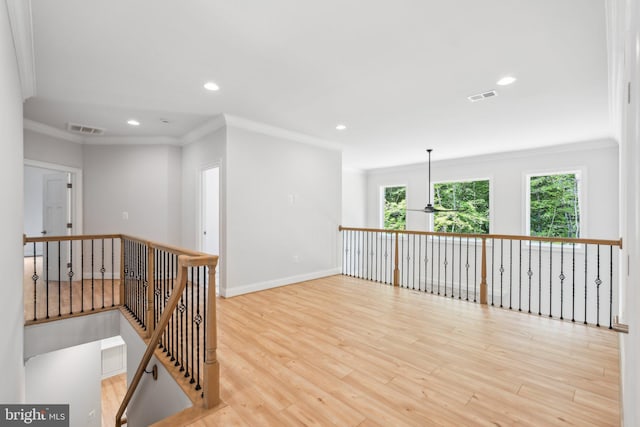 unfurnished room featuring light hardwood / wood-style floors and ornamental molding