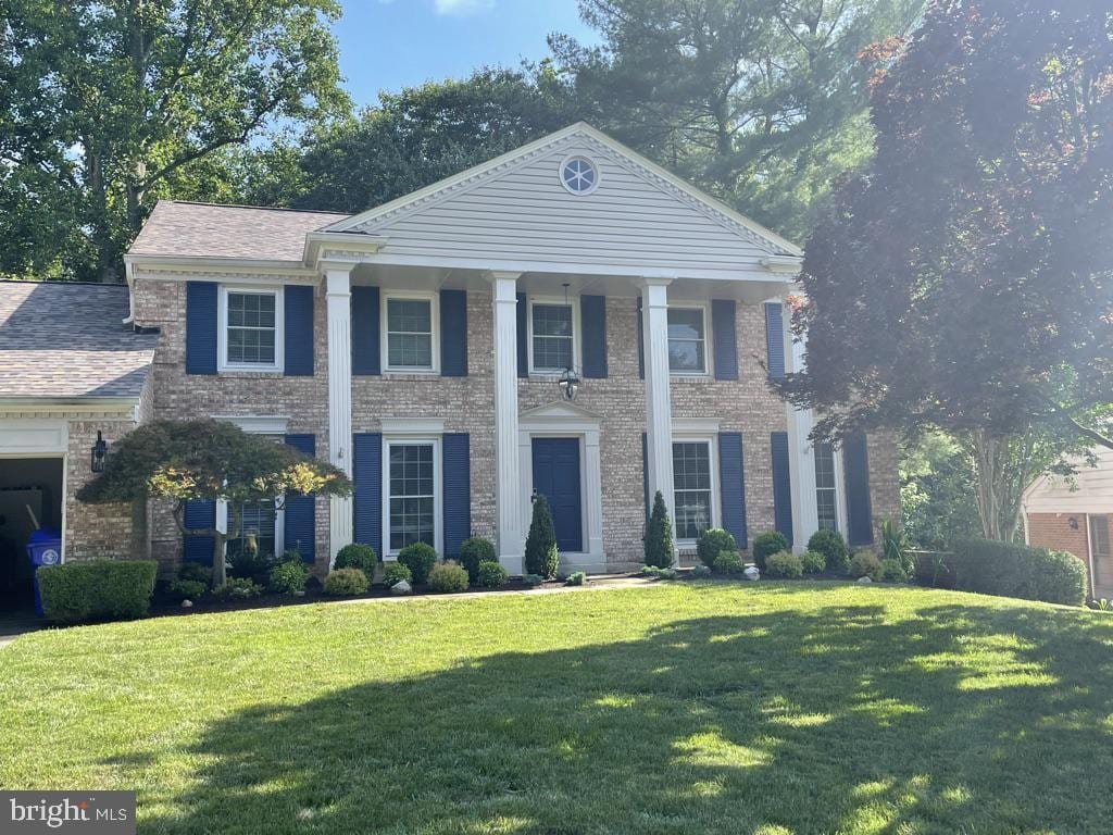 greek revival inspired property with a front lawn