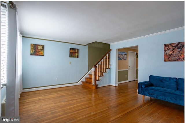 living room featuring wood-type flooring and ornamental molding