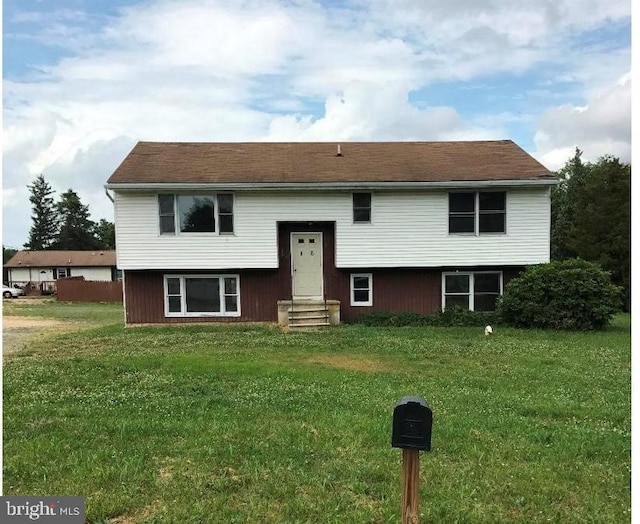 bi-level home with a front lawn