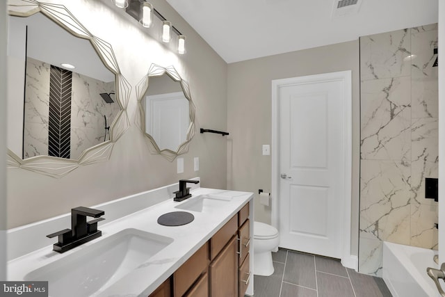 full bathroom with vanity, toilet, tiled shower / bath, and tile patterned floors