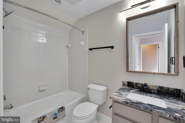 full bathroom featuring tiled shower / bath combo, vanity, and toilet