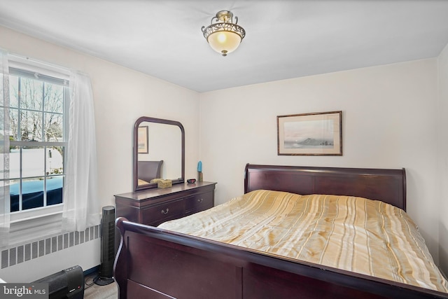 bedroom featuring radiator