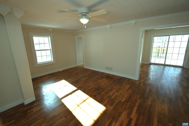 spare room with crown molding, dark wood-type flooring, and ceiling fan