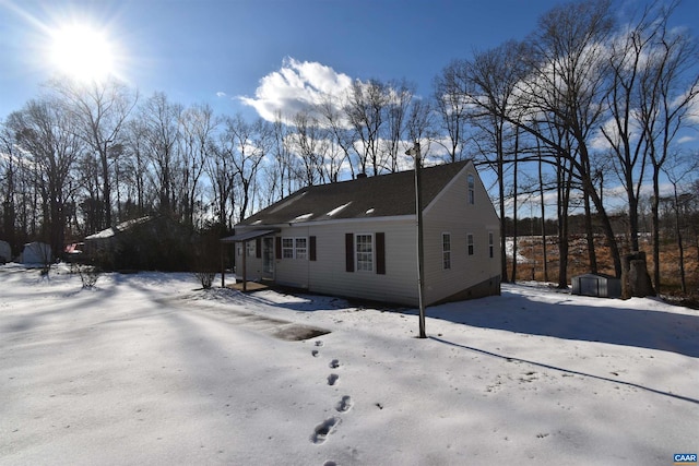 snow covered property featuring a storage shed