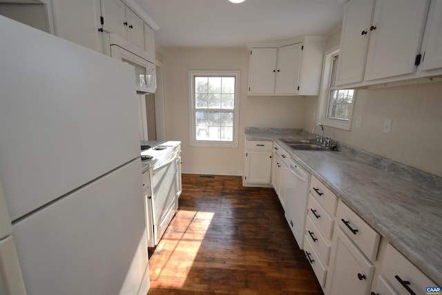 kitchen with white cabinets, white appliances, dark hardwood / wood-style flooring, and sink