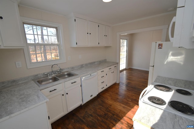 kitchen with sink, white appliances, and white cabinets