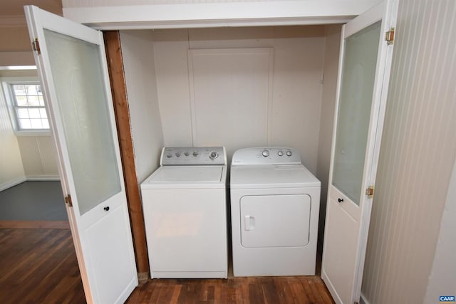 washroom featuring washing machine and dryer and dark wood-type flooring