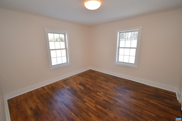 spare room featuring dark hardwood / wood-style floors