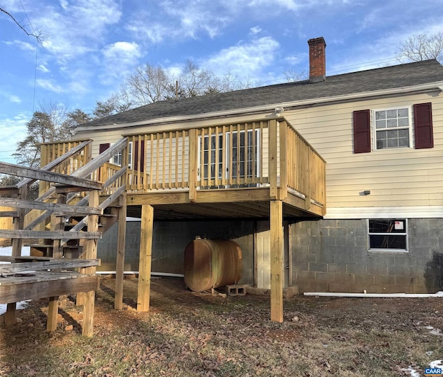 back of house featuring a wooden deck