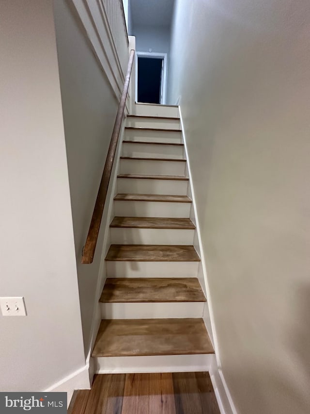 stairway featuring wood-type flooring