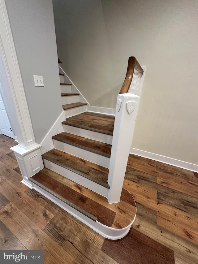 stairway featuring hardwood / wood-style flooring