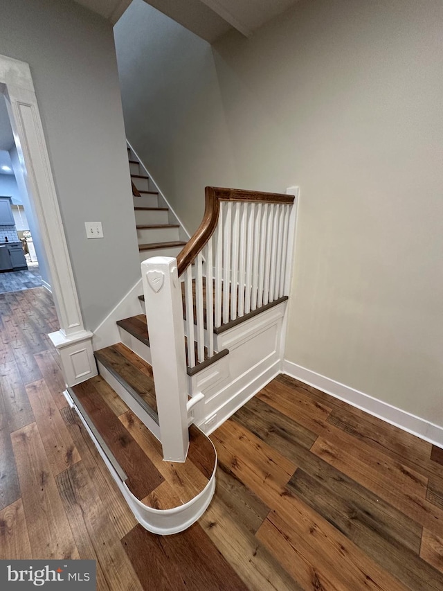 stairway with hardwood / wood-style flooring