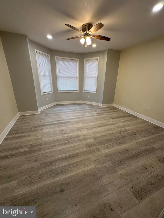 unfurnished room featuring ceiling fan and wood-type flooring