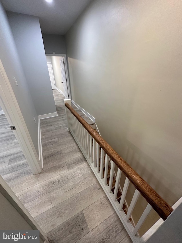 stairway with hardwood / wood-style floors