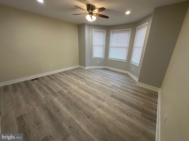 spare room with ceiling fan and wood-type flooring