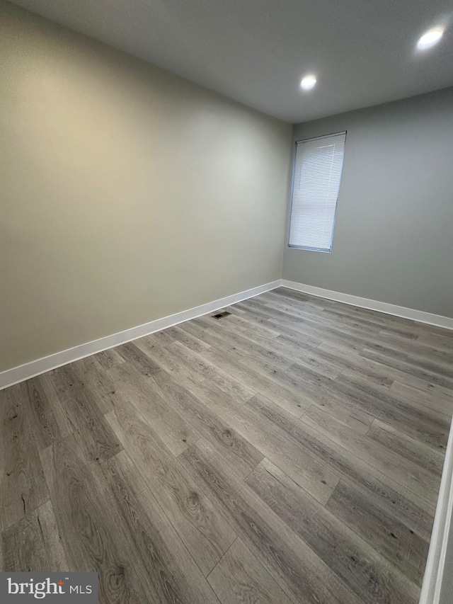 unfurnished room featuring hardwood / wood-style floors