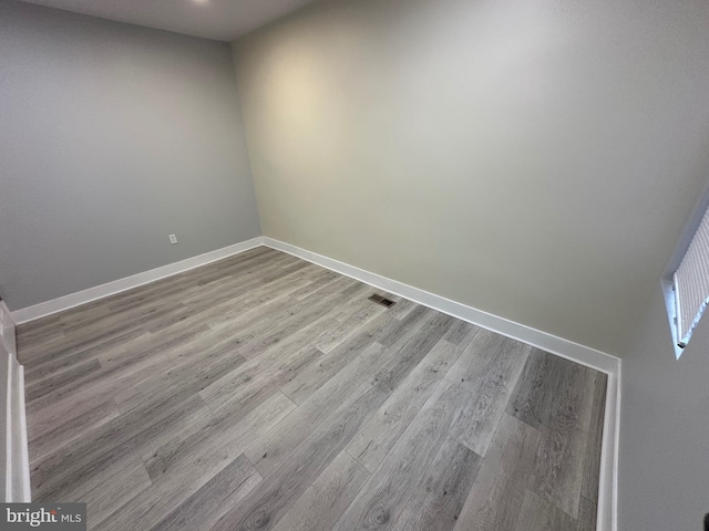 unfurnished room with light wood-type flooring