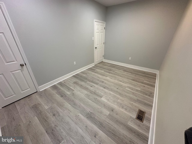 empty room with light hardwood / wood-style floors