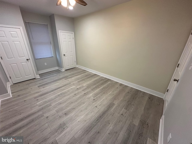 unfurnished bedroom featuring light hardwood / wood-style flooring and ceiling fan