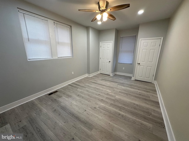 unfurnished bedroom featuring light hardwood / wood-style flooring and ceiling fan