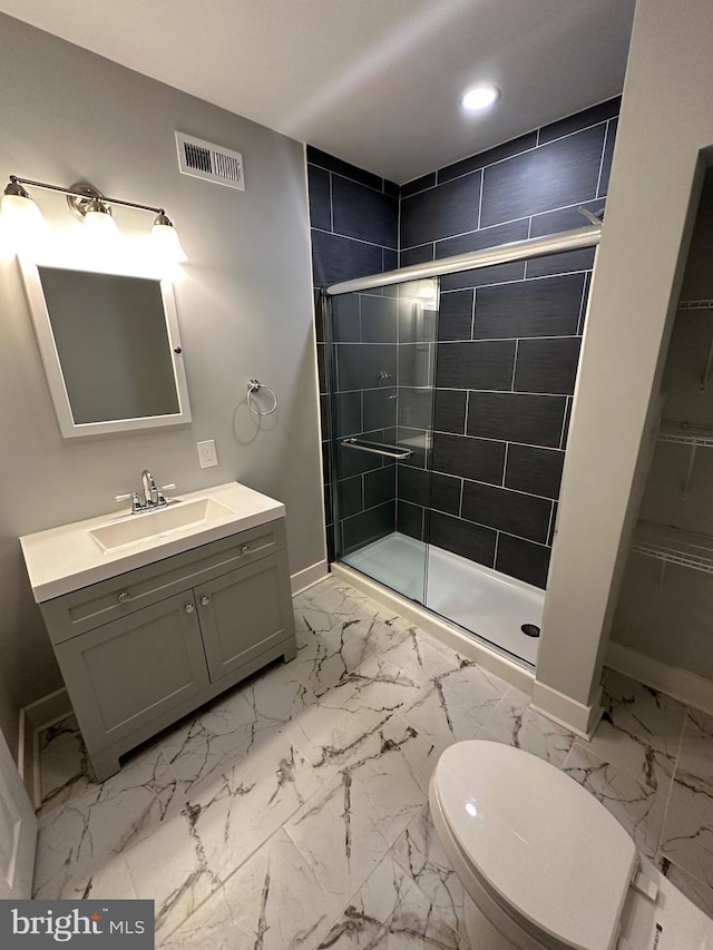 bathroom featuring toilet, walk in shower, and vanity