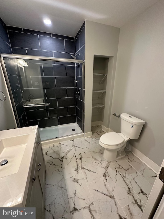 bathroom with vanity, toilet, and walk in shower