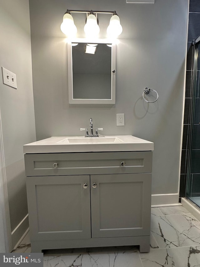 bathroom with vanity and a shower with door