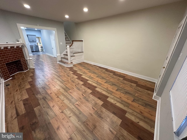 unfurnished living room featuring dark hardwood / wood-style flooring