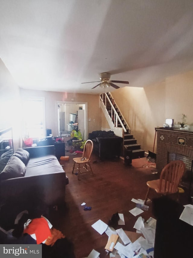 living room featuring a fireplace and ceiling fan