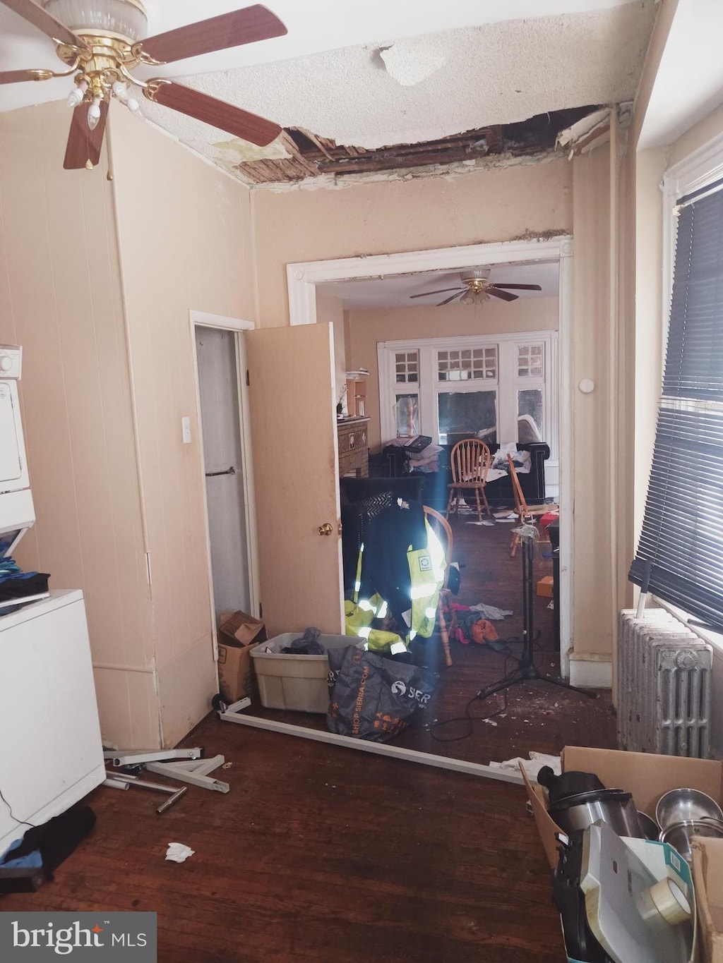 interior space with ceiling fan, wood-type flooring, and radiator