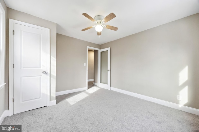 unfurnished bedroom featuring ceiling fan and carpet flooring