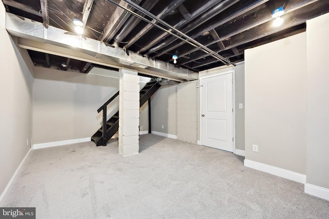 basement featuring light carpet